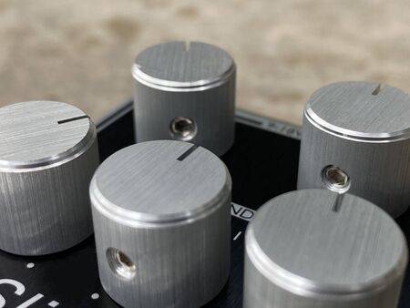 Close-up Silver metal knob and black control panel plate of boutique distortion Stomp box electric guitar effect.の写真素材