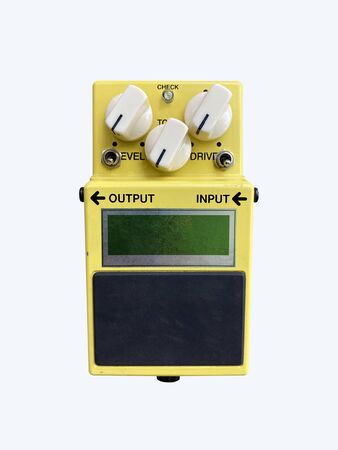 Isolated yellow vintage Overdrive stomp box effect for electric guitar on white background with work...