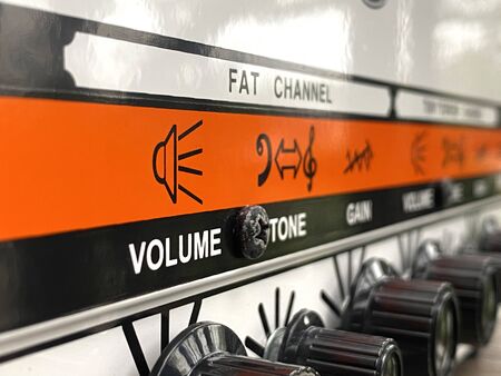 Close-up modern head power amplifier with black knob and control panel. clean and hi-gain distortion for rock to metal, Blues, and jazz genres. Music business concept.の写真素材