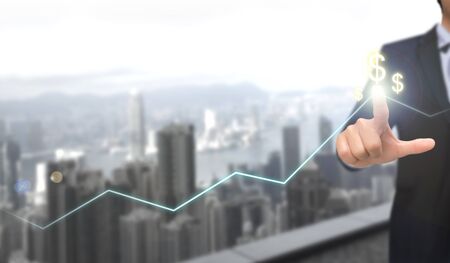 the businessman is drawing a glowing stock chart that is going well with an index finger. business and analyzing financial and investment data, business planning, and strategy concept.の写真素材
