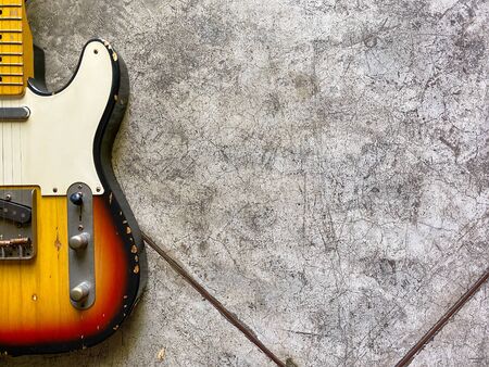 sunburst electric guitar made from a genuine Ashwood Popular musician on veneer brown wood background with copy space on right for letter. business and music concept. Wallpaper or background. top view.の写真素材