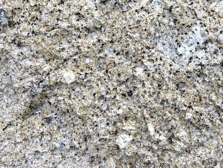 Close-up shot of a large rock with a white and gold dividing beside the sea that has been eroded by the sea until it is beautiful for artwork or graphic design. wallpaper, background, or backdrop.の写真素材