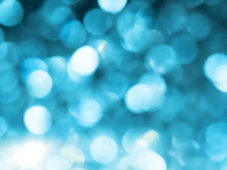 Abstract colorful blue and silver big bokeh Looks bright effect texture on black background. glitter vintage lights defocused elegant for Christmas or celebrate. Sparkling magical dust particles.の写真素材
