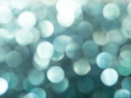 Abstract colorful grey and silver big bokeh Look bright effect texture on black background. glitter vintage lights defocused elegant for cosmetics or celebrate. Sparkling magical dust particles.の写真素材