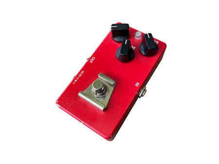 Isolated red texture overdrive stompbox electric guitar effect for studio and stage performed on white background  . side view photo. music concept.の写真素材