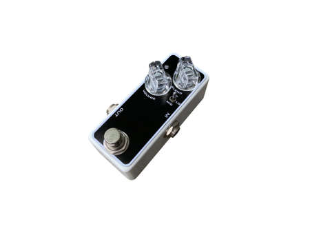 Isolated grey boutique overdrive stompbox electric guitar effect for studio and stage performed on white background with clipping path. side view photo. music concept.の写真素材