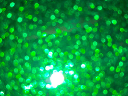Abstract colorful green bokeh gradient effect texture on black background. glitter modern lights defocused look luxury and elegant for celebrate. Sparkling magical dust particles.の写真素材