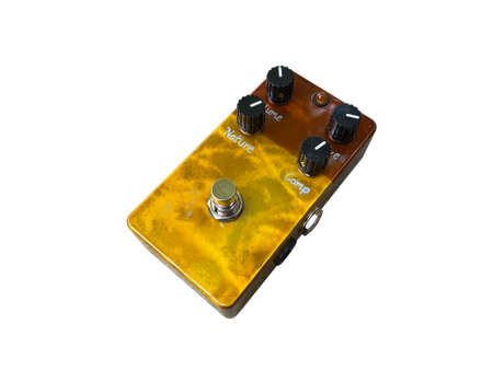 Isolated Brown and gold stompbox electric guitar effect for studio and stage performed on white background with clipping path. side view photo. music concept.の写真素材