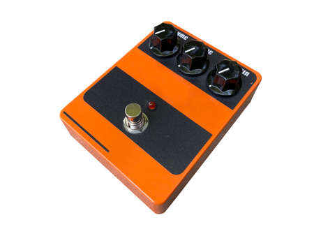 Isolated orange overdrive stompbox electric guitar effect for studio and stage performed on white background . side view photo. music concept.の写真素材