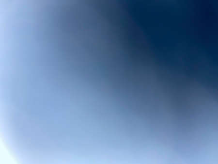 Abstract photos That has the light from white to dark blue Caused by the flashlight while the camera fell onto the jean cloth Can be used instead of len flare or as an image effect with copy space.の写真素材