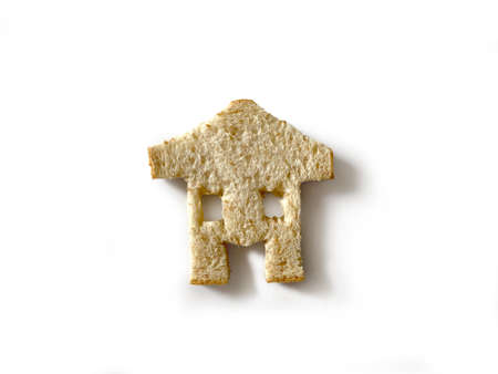 Bread slices that are cut into Cut into a house and whole wheat bread slices with clipping path. Smells delicious Placed on white background. Ideas and concepts Comparative and Business.の写真素材