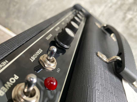 Close-up modern amplifier with black knob and control panel. clean and hi-gain distortion for rock to metal, Blues, and jazz genres in music store. Music business concept.の写真素材