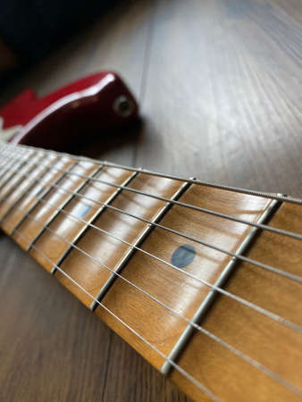 Close-up the gain silver knob of the boutique distortion guitar amplifier with blurred gray control...