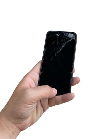 hand of a person holding a black Broken screen smartphone with copy space. Isolated on white background . It can be used to promote the phone repair shop.の写真素材