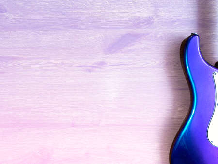 Iridescent electric guitar made from a genuine alder Popular musician on veneer brown wood background with copy space for letter. business and music concept. flat lay background. top view.の写真素材