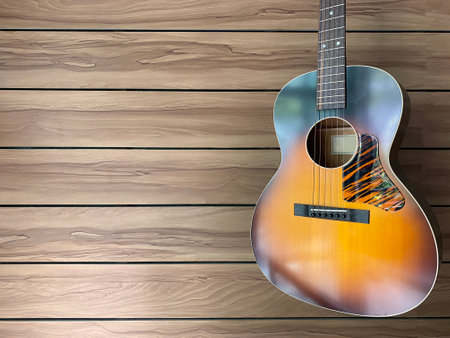 natural sunburst acoustic guitars hung on a brown ash wood grain wall in a music shop with copy space on the right hand for text.music or menu coffee shop concept.の写真素材