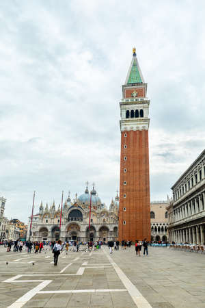St. Mark's Sqaure Venice, Italy. March 22, 2020. Photograph of the famous St. Marks Square Bell Tour. Amazing travel destination for tourists and Honeymooners. Absolutely breathtaking and beautiful. With Tourists in squareのeditorial素材