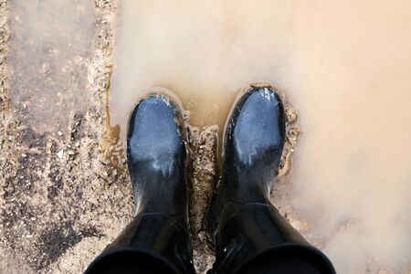 Black Boots Standing in Mudの写真素材
