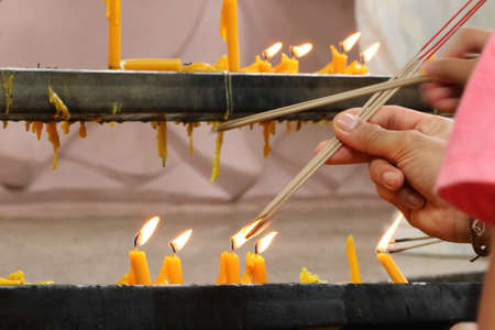 people light up candle and incenseの写真素材