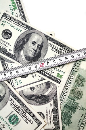 money with tape measure isolated on white backgroundの写真素材