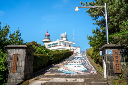 Udo (Cow Island), Jeju island, South Korea - Jun. 06, 2023: Beautiful Udo Lighthouse at Udobong peak (Udo mountain) beside Jeju do (Jeju island).のeditorial素材