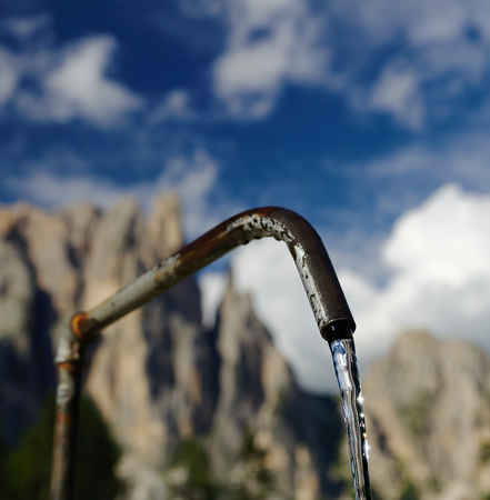 Spring water from the source in Italian Dolomitesの写真素材