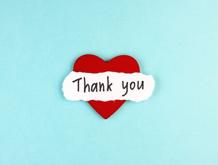 healthy red heart and the inscription Thank you on a blue background. concept of gratitude to medical workers during the coronavirus pandemicの写真素材