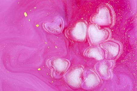 Pink abstract background of ice hearts. Love concept, modern style. Romantic card with frozen heart. Symbol of Valentine day. Cool texture, pattern. Laconic art design.の写真素材