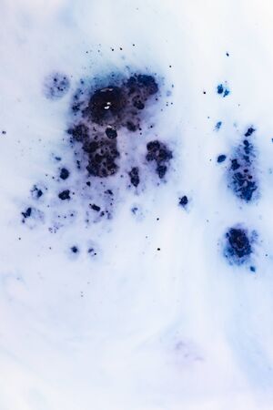 Amazing colorful blue agate Crystal cross section isolated on white background. Natural translucent surface of agate crystal, blue abstract structure of mineral stone macro close-upの写真素材