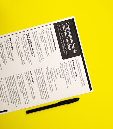 application for unemployment benefits with money. the concept of applying for insurance payments from the state in case of dismissal due to covid-19 coronavirusの写真素材