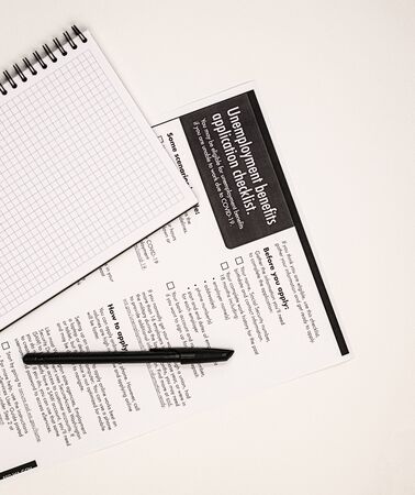 application for unemployment benefits with money. the concept of applying for insurance payments...