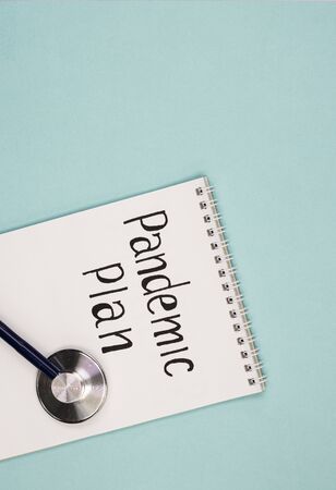 white Notepad, and a phonendoscope with the words pandemic plan. the concept of building a different plan because of the coronavirus pandemicの写真素材