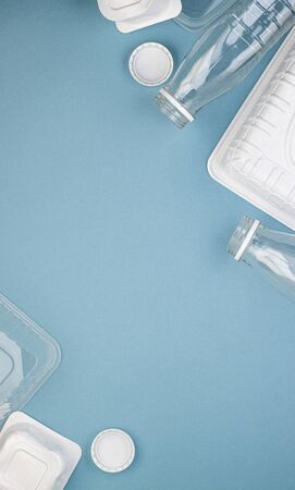 Empty plastic bottles with white lids, packages and dishes in a pile. The concept of encouraging...