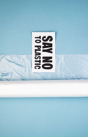A roll of plastic bag marked say no to plastic. The concept of asking people not to use plastic items to prevent contamination of the environment and ecology. The rejection of the plasticの写真素材