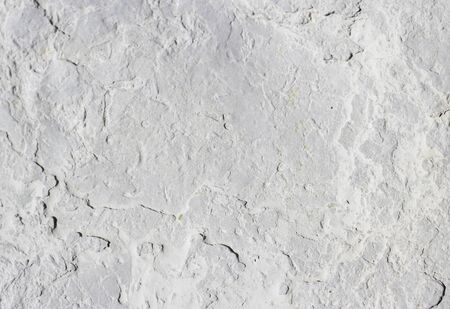 abstract texture of coastal white stone for background, close-up. rough, uneven surface of the rock pebblesの写真素材