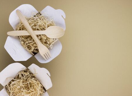 eco food containers and eco food containers with wooden spoons and forks on a light background with space for text. caring for nature, preserving the purity of the planetの写真素材