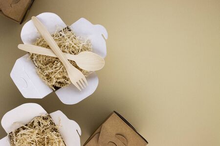 eco tableware and eco food containers with wooden spoons and forks on a light background with space for text. caring for nature, preserving the purity of the planetの写真素材