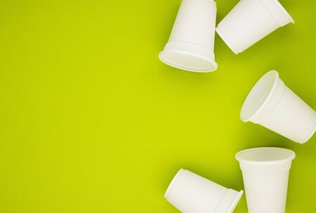 biodegradable beverage containers on a green background, space for text. environmental protection....