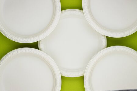 Eco-friendly biodegradable paper plates on a green background. preserving the purity of nature. the rejection of the plasticの写真素材