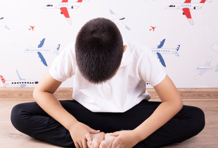 the boy does sports exercises to the floor. healthy lifestyle. children's educationの写真素材