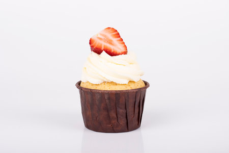 cupcake with strawberries and cream cheese cream. air cake with creamの写真素材