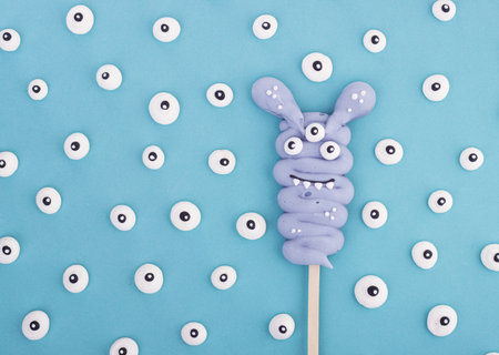 Funny meringue ghosts for Halloween. funny sweet monsters on a stickの写真素材
