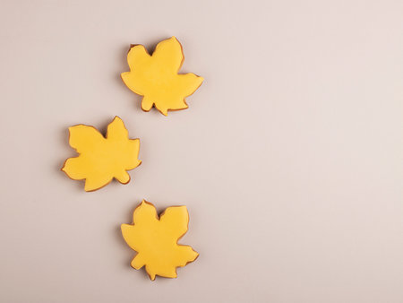 Home autumn gingerbread background of yellow leaves, top view, space for text. concept of autumn and home comfortの写真素材