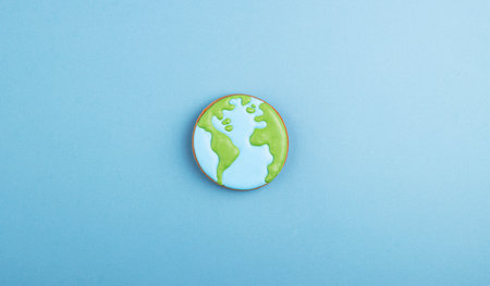 gingerbread planet earth on a blue background. christmas gingerbread painted with icingの写真素材
