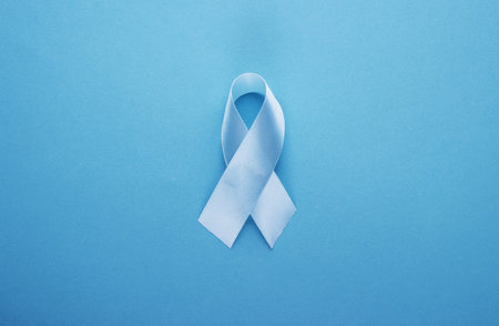 blue ribbon on a blue background. world day of fight against cancer. men's and women's health