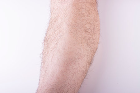 Naked hairy male legs isolated on white background. foot skin care, men's hair removal. men's healthの写真素材