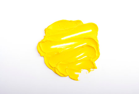 Beautiful textured golden yellow stroke isolated on white background. yellow paint smearの写真素材