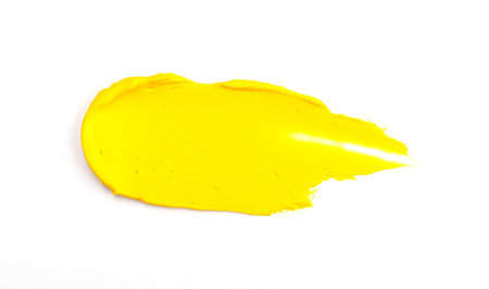 Beautiful textured golden yellow stroke isolated on white background. yellow paint smearの写真素材