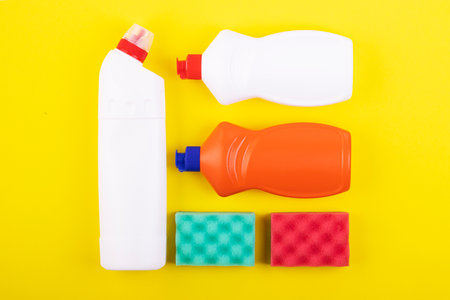 cleaning products display nolling on a yellow background, top view. the concept of cleaning and cleanlinessの写真素材