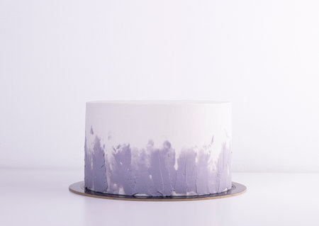 stylish white cake with gray gradient on a white table. cake for a holiday and birthdayの写真素材